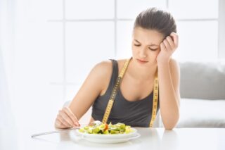 woman ponders how she can continue to maintain her weight loss 