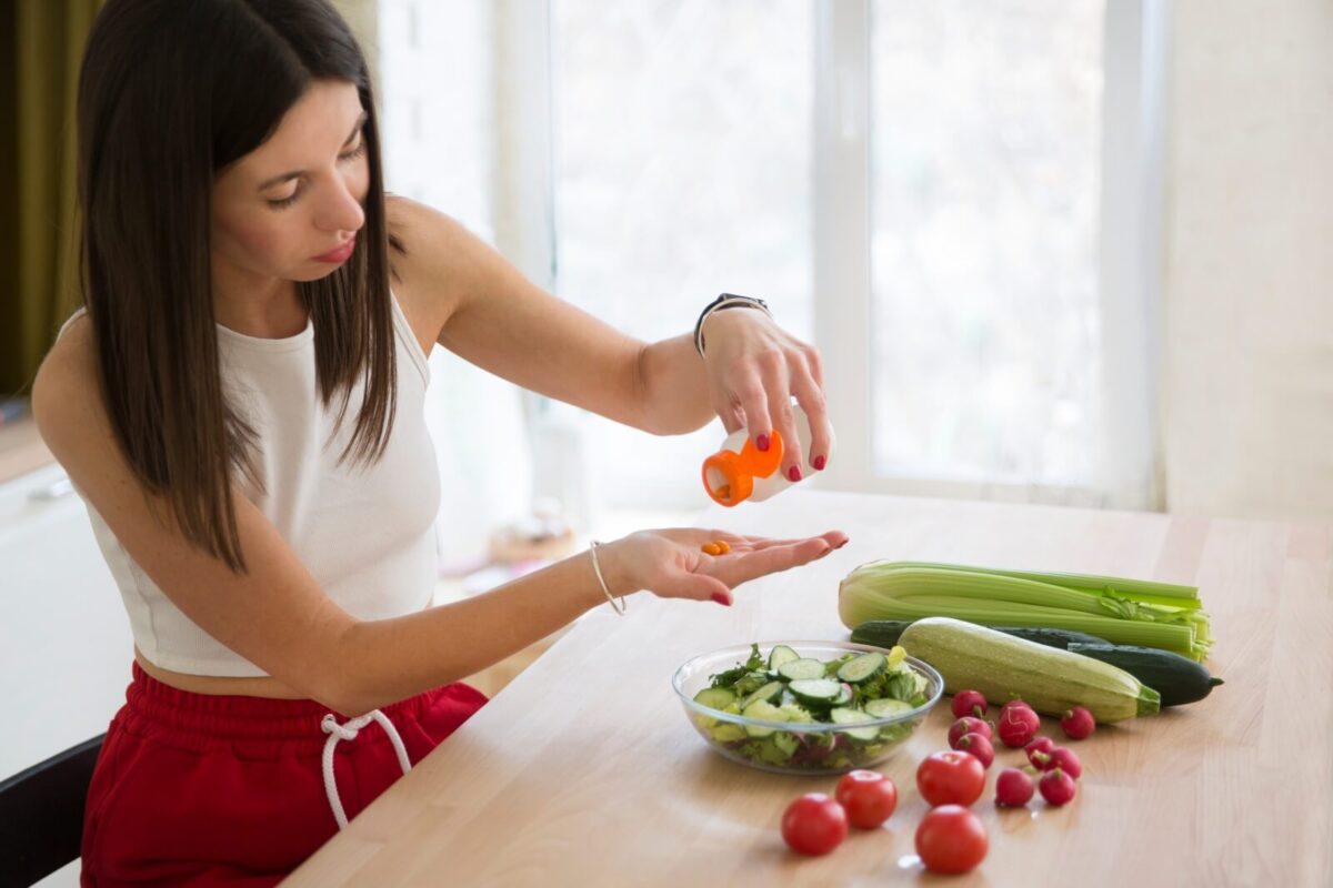 Woman takes supplements to help combat sugar withdrawal symptoms